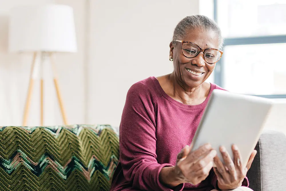 Senior Aged Woman with Tablet Filling out Aging Choices Checklist Senior Aged Woman with Tablet Filling out Aging Choices Checklist